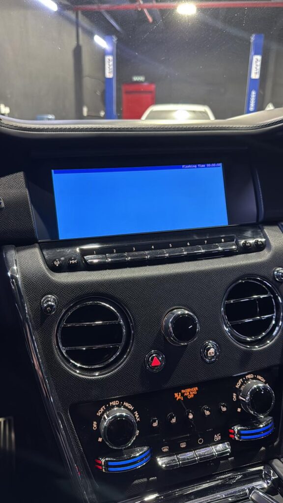 Rolls-Royce Cullinan head unit during firmware flashing process for GCC conversion at Weiss Auto Concept Dubai workshop