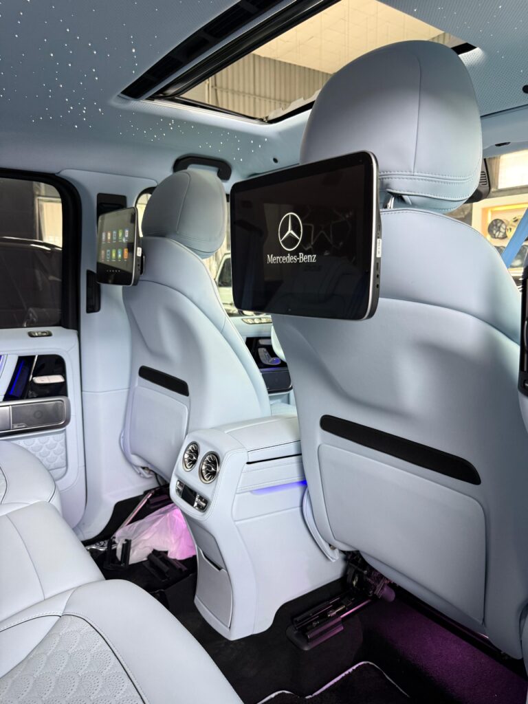 2025 Mercedes G63 OEM headrest monitor with Mercedes-Benz logo installed in Dubai by Weiss Auto Concept