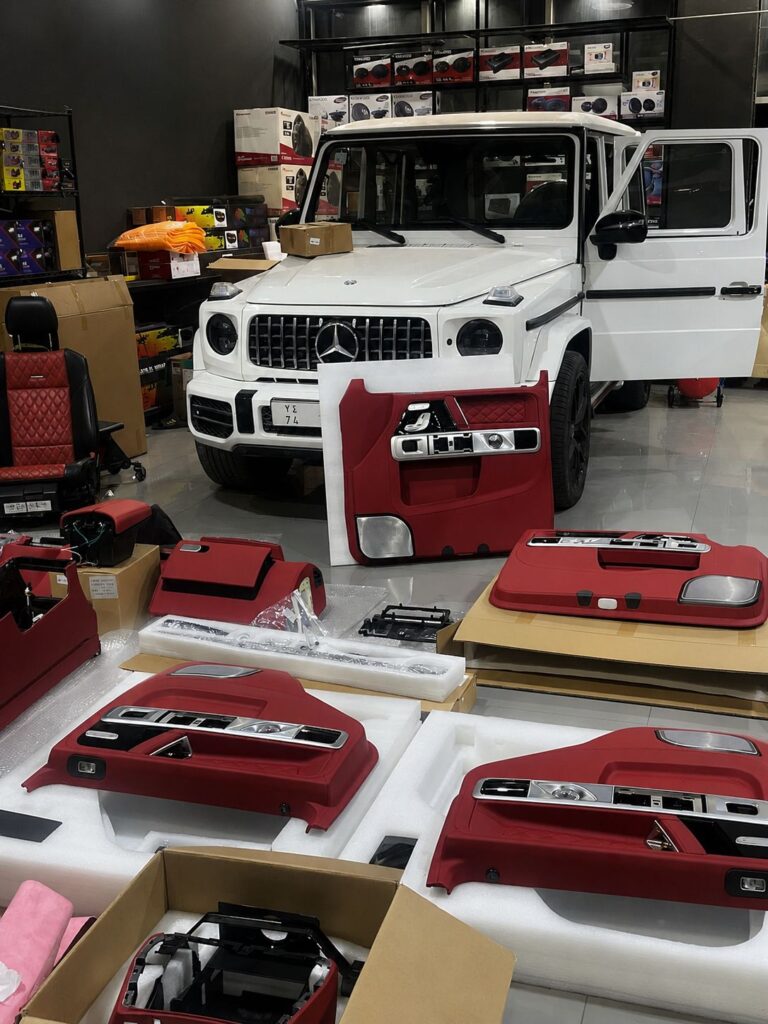 New W464 red leather interior kit parts laid out before installation on Mercedes G63 in Dubai by Weiss Auto Concept