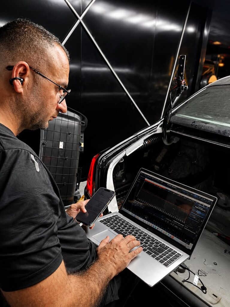 Weiss Auto Concept technician tuning a Rolls-Royce Ghost sound system in Dubai