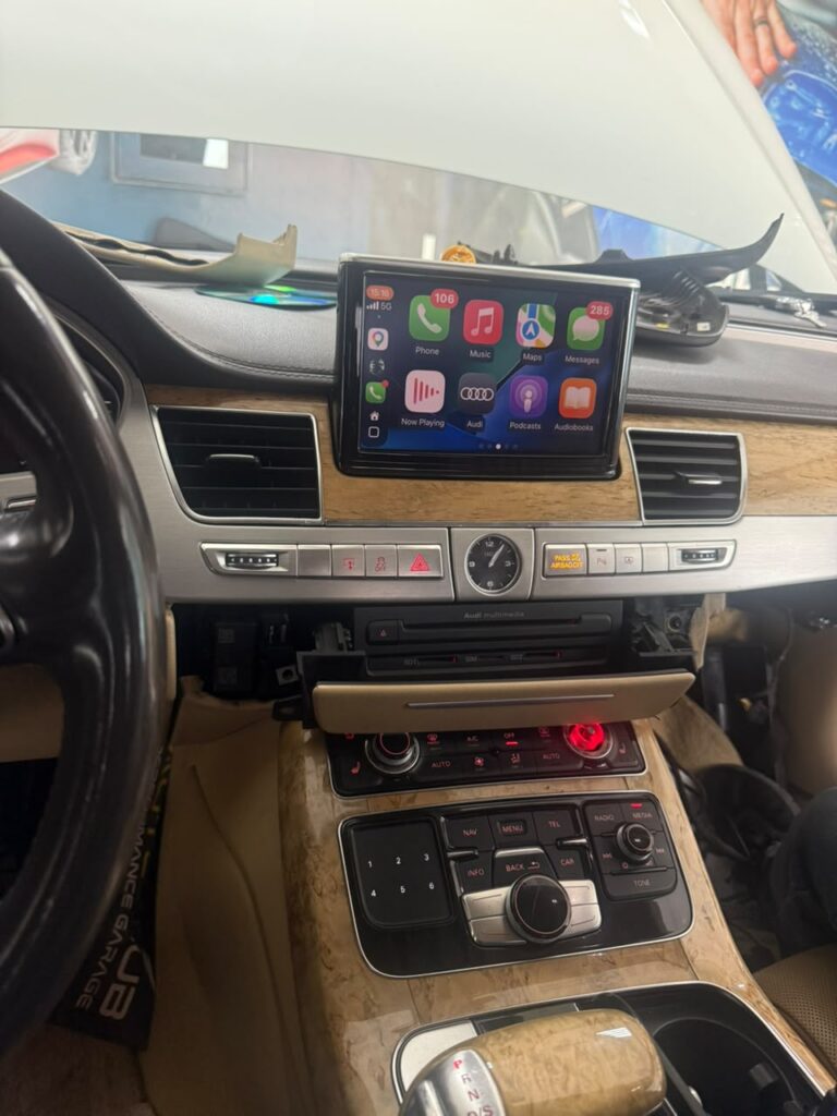 Wireless Apple CarPlay running on the factory MMI 3G screen of a 2012 Audi A8 at Weiss Auto Concept Dubai
