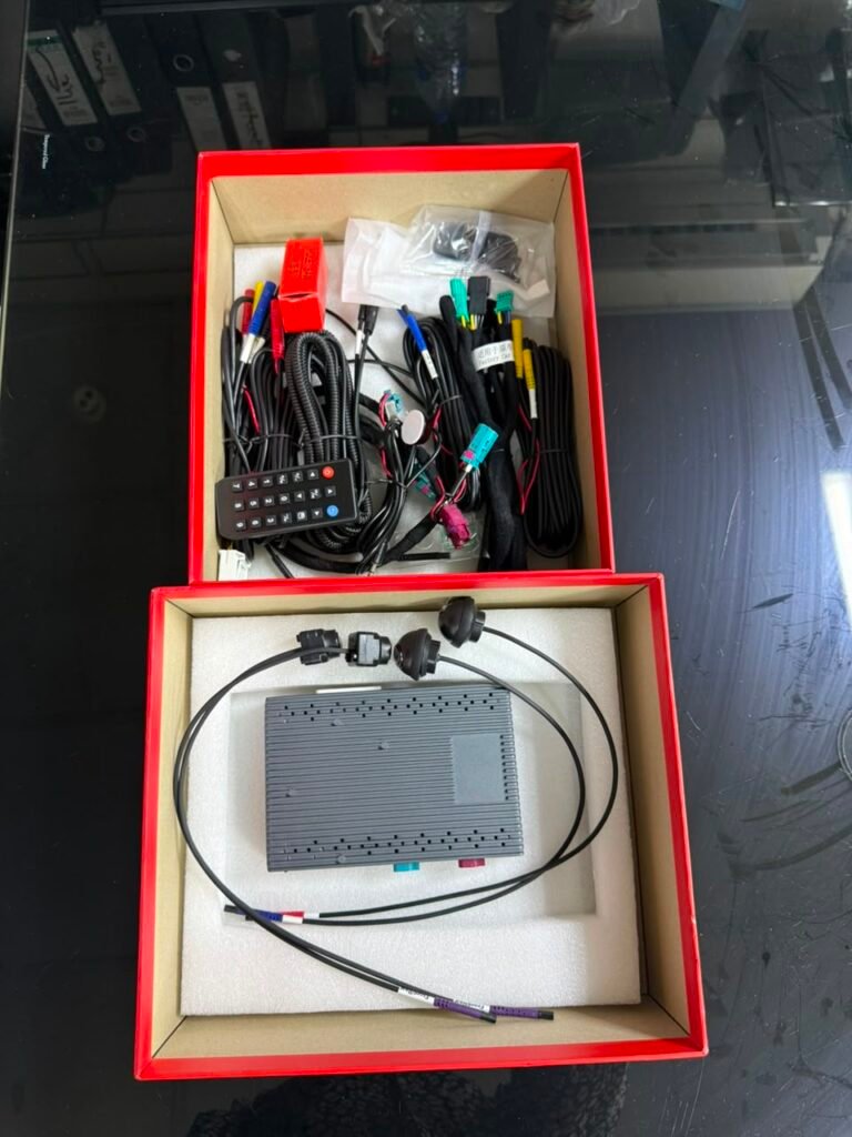 BMW 360 camera kit contents including interface box, four cameras, wiring harnesses and remote control