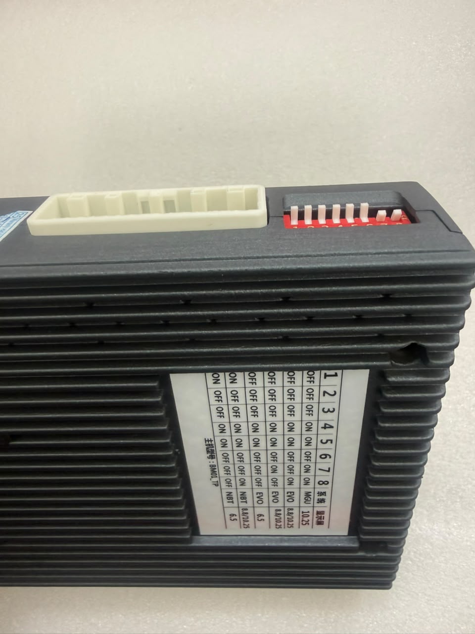 Close-up of BMW 360 camera interface DIP switch with system setting sticker, main power connector and four camera inputs
