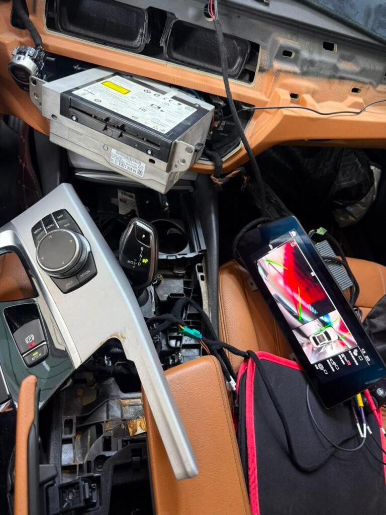 BMW 5 Series G30 dashboard opened during 360 camera interface installation at Weiss Auto Concept Dubai