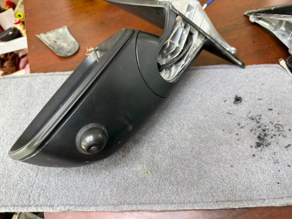360 degree camera installed under the side mirror housing of a BMW 5 Series G30