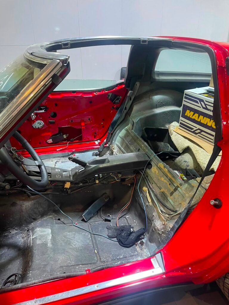 Corvette C3 cabin fully stripped to bare shell during interior restoration in Dubai