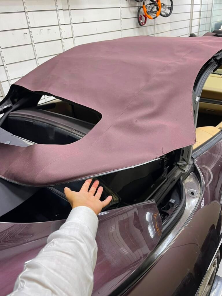 Soft top fabric being fitted over the Porsche 911 frame at Weiss Auto Concept