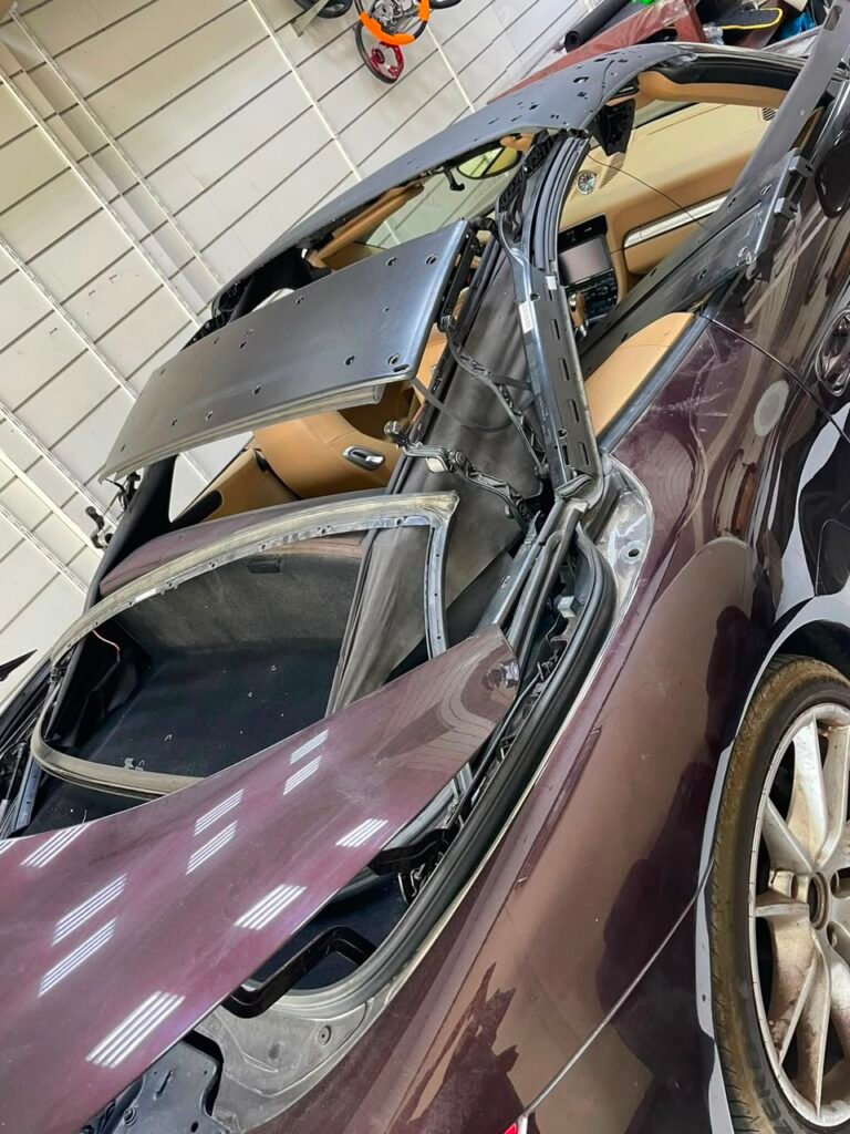Porsche 911 convertible frame with old soft top removed at Weiss Auto Concept Dubai