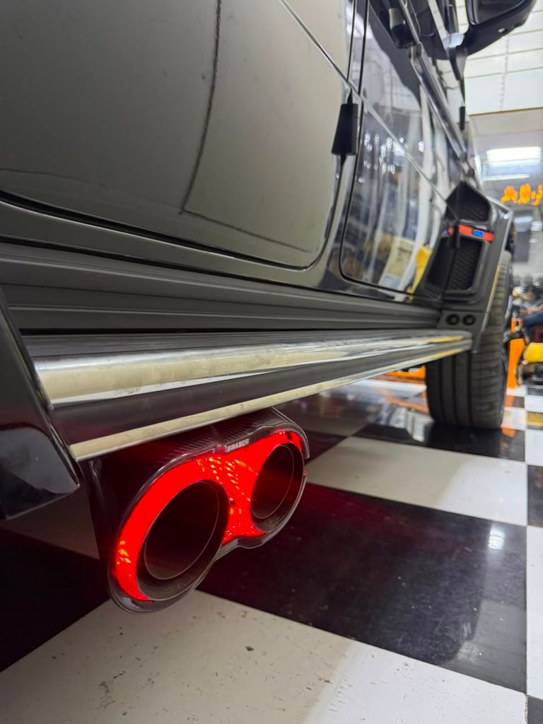 Brabus-style carbon exhaust tips with red LED lighting on a 2022 Mercedes-AMG G63 in Dubai by Weiss Auto Concept